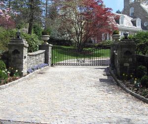 Wrought-iron driveway gate with initials, designed and installed by Tri State Gate, New York