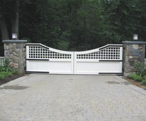 Updated design trellis and solid panel wooden driveway gate by Tri State Gate, New York