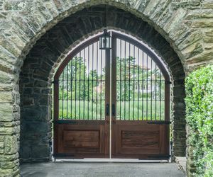 Spanish/Moroccan-inspired arched driveway gate design with vestibule entry by Tri State Gate, New York