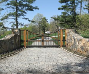 Spanish-inspired wooden driveway gate by Tri State Gate, New York
