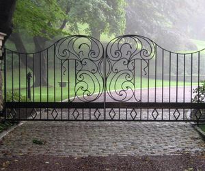 Attractive scrollwork on this custom designed, wrought-iron entry gate by Tri State Gate, New York