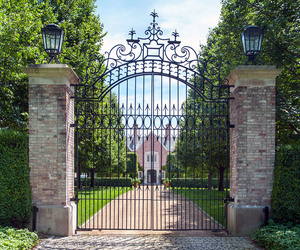 Tall, narrow, wrought-iron driveway gate