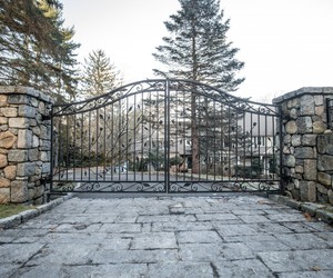 Custom wrought-iron driveway gates with flower and vine details by Tri State Gate