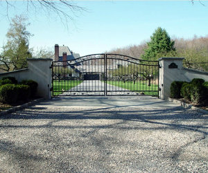 Wrought-iron driveway gate with custom posts, by Tri State Gate, New York