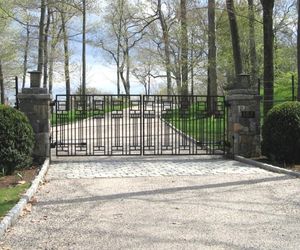 A unique Art Deco design on this iron driveway entry gate system by Tri State Gate, New York