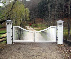 White wood gate, wood-wrapped posts with integrated lighting by Tri State Gate, New York