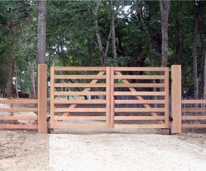 A simple wood gate to allow automated entry for farm equipment and animals, by Tri State Gate, New York