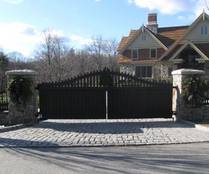 Solid wood driveway gate with picket detail on top, by Tri State Gate, New York