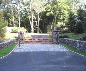 Farm-style cedar wood gate with modern updates by Tri State Gate, New York
