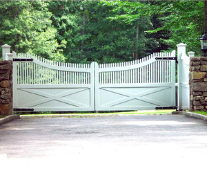 Transitional-style farmhouse design driveway gate by Tri State Gate, New York
