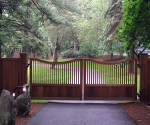 Double scalloped wooden gate, wood-wrapped posts, secure entry system by Tri State Gate, New York