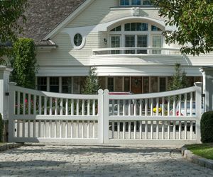 Scalloped wood gate with wrapped posts by Tri State Gate, New York